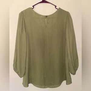 Green 3/4 sleeve sheer blouse. Barely worn. “Button” details on shoulders.